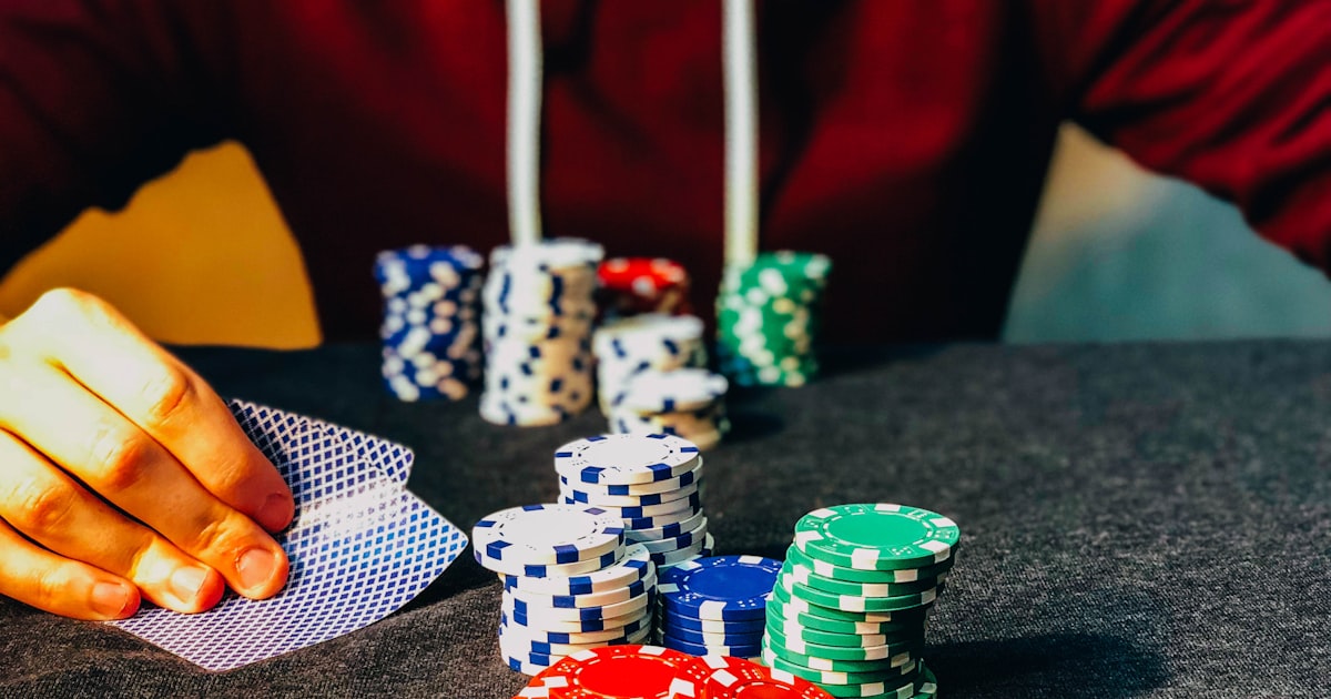Poker table with chips and cards mid-tournament under warm light